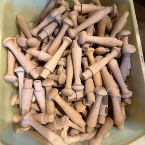 Set of 12 shaker style unfinished wooden pegs.